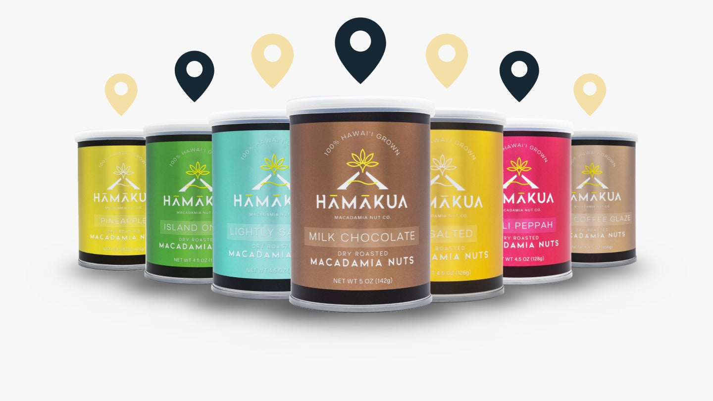Assorted new Hāmākua Macadamia Nut Company packaging on a white background with location icons above them.
