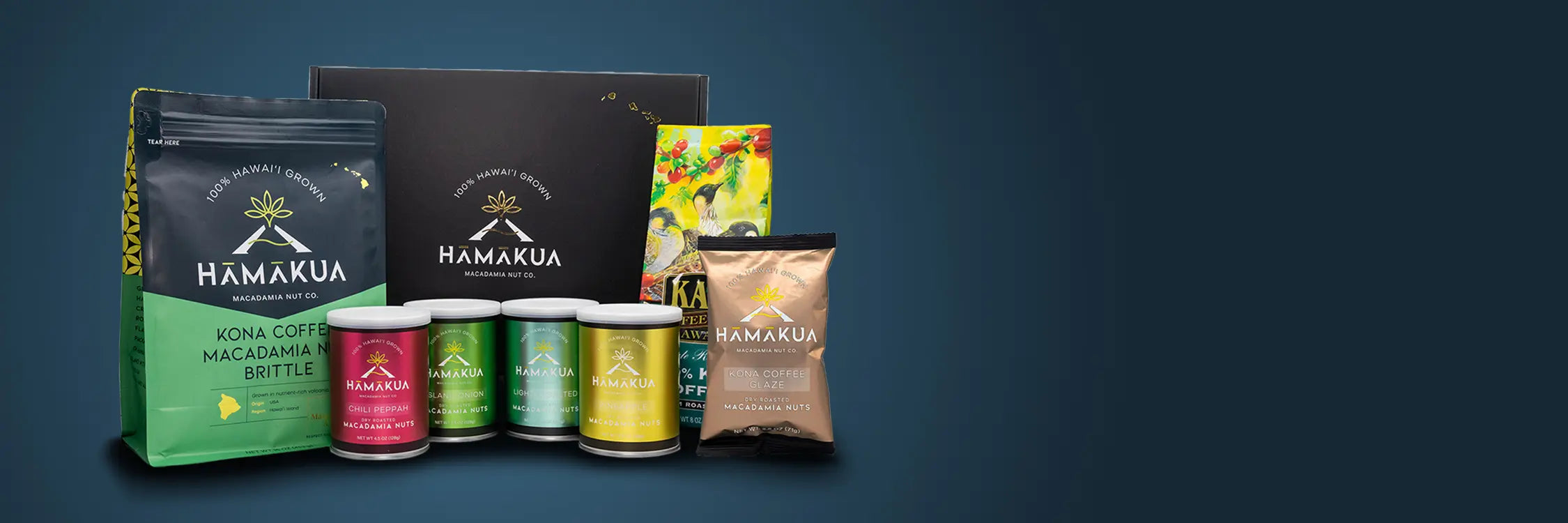 Collection of Hāmākua Macadamia Nut Company and Kaʻū Coffee Mill products including coffee, brittle, and macadamia nuts on a dark blue gradient background.