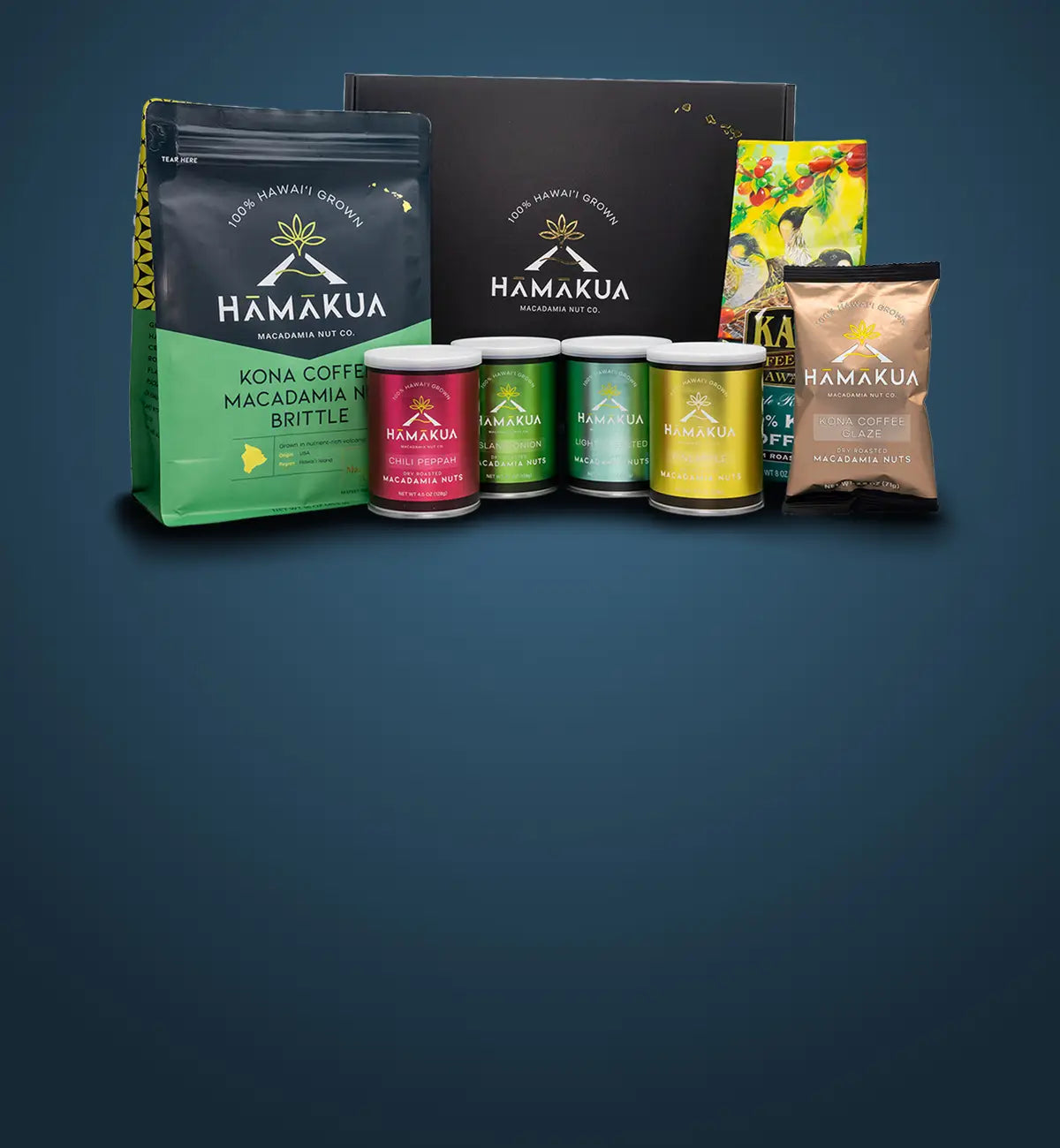 Collection of Hāmākua Macadamia Nut Company and Kaʻū Coffee Mill products including coffee, brittle, and macadamia nuts on a dark blue gradient background.