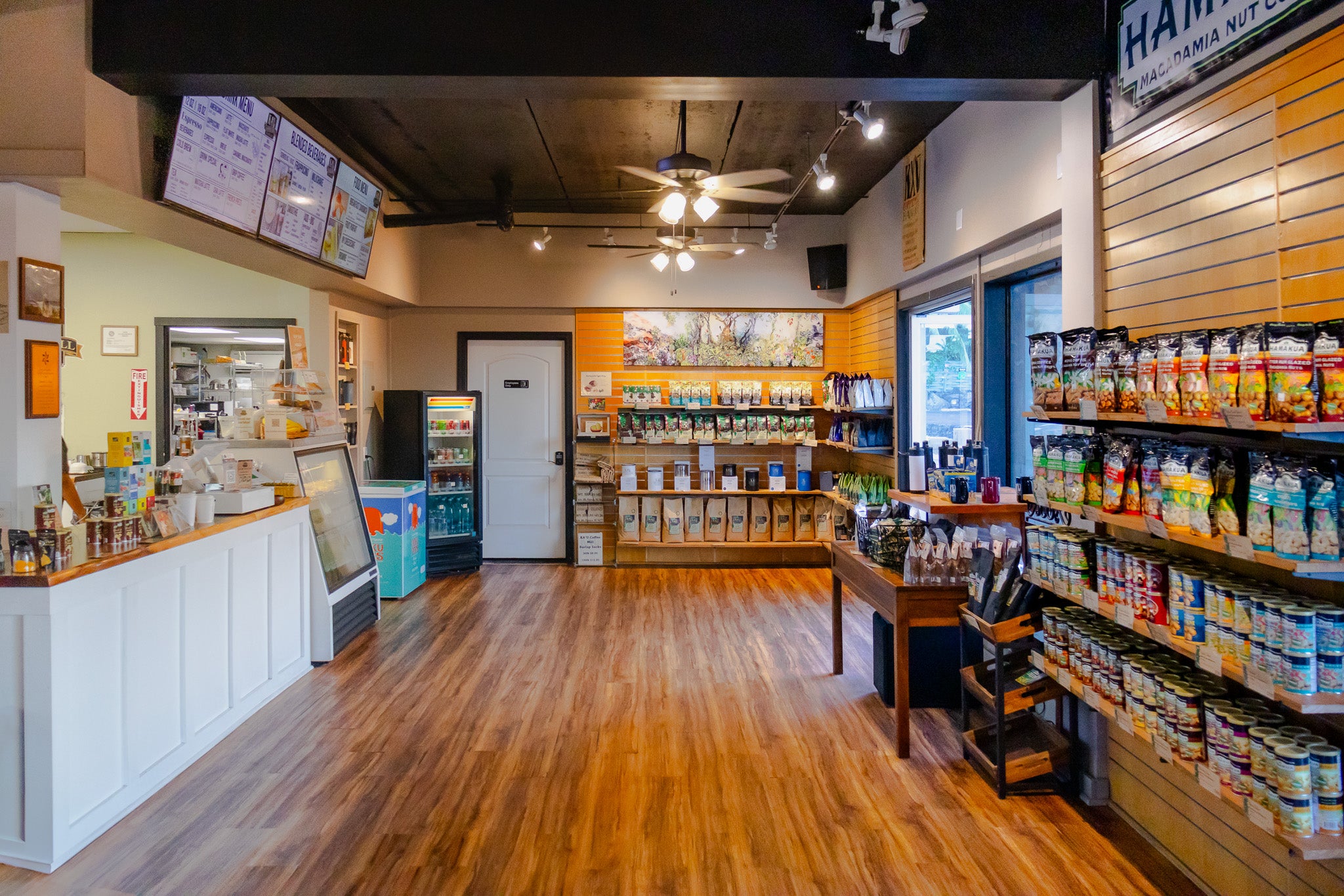 Interior of Kaʻū Coffee Mill Cafe with shelves of products and ordering counter