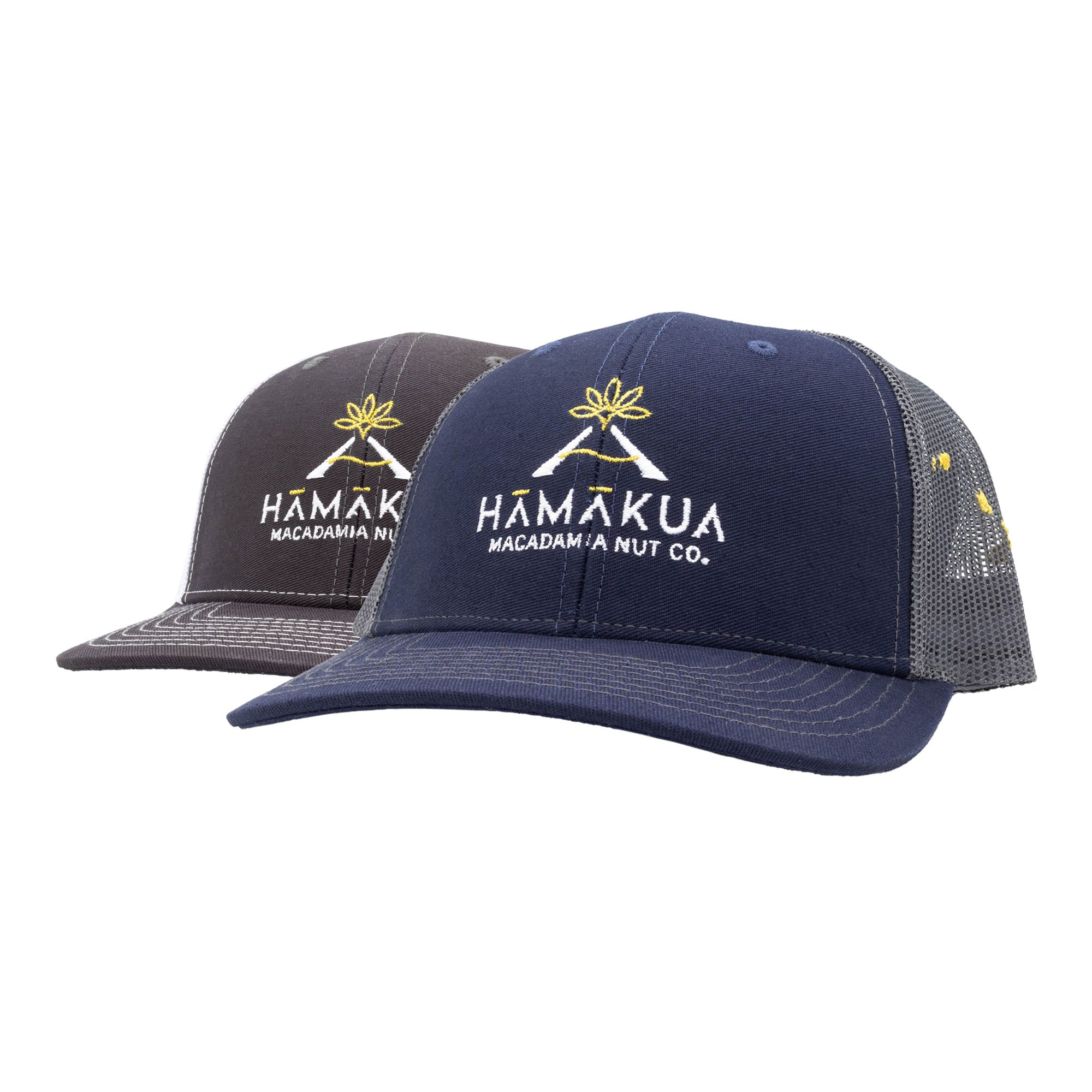 Two trucker hats with Hamakua Macadamia Nut Co. logos
