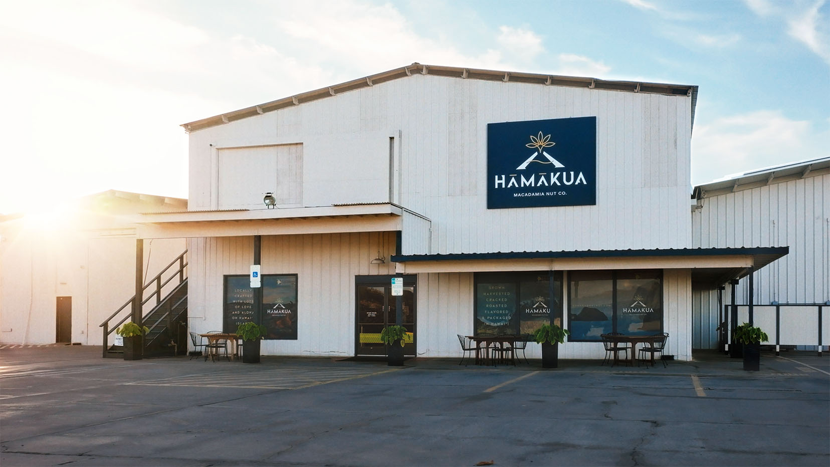 Visitor Center Exterior with Hāmākua Macadamia Nut Co logo on outside of building.