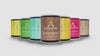 Different colors of Hāmākua Macadamia Nut Co. cans with location icons floating above